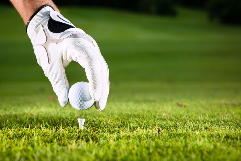 placing golf ball on a tee